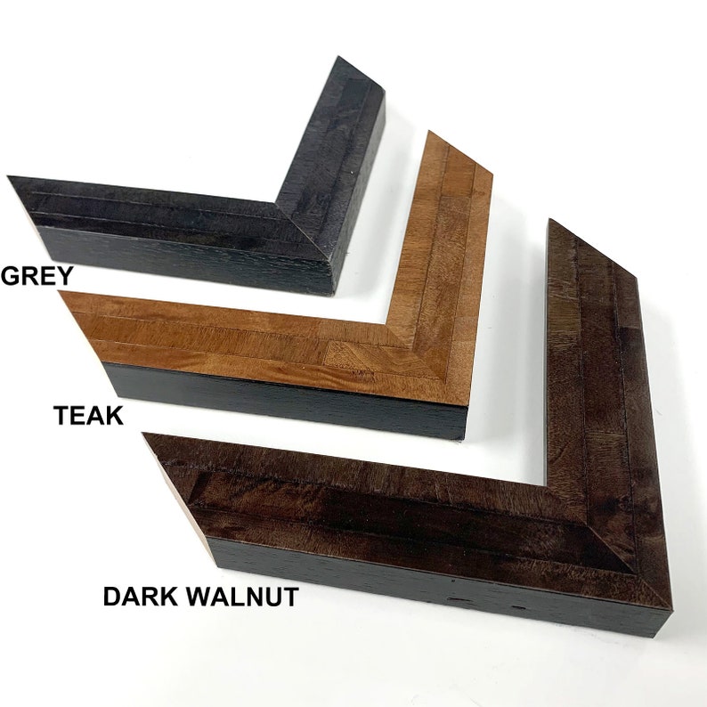 May include: Three picture frame samples in different wood finishes: grey, teak, and dark walnut.