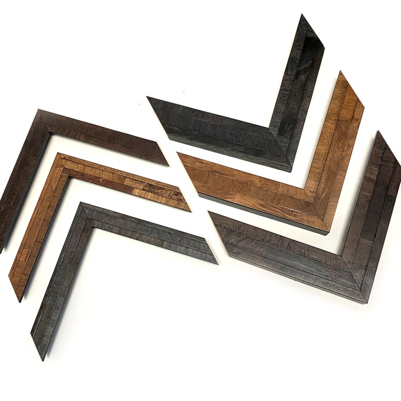 May include: Five picture frames in different wood tones and finishes. The frames are arranged in a chevron pattern, with the darkest frame at the bottom and the lightest frame at the top.