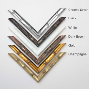 May include: Six picture frames in different colours, including chrome silver, black, white, dark brown, gold, and champagne. The frames are all made of a wood-like material and have a decorative design.