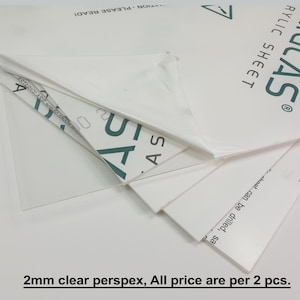 May include: A stack of clear 2mm thick acrylic sheets. The sheets are labelled "Astariglas Acrylic Sheet". The text "2mm clear perspex, All price are per 2 pcs." is visible at the bottom of the image.
