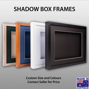 May include: Four shadow box frames in different colours: green, orange, white, and black. The frames are made of wood and have a simple design. The text "SHADOW BOX FRAMES" is at the top of the image. The text "Custom Size and Colours Contact Seller for Price" is at the bottom of the image. The text "MADE IN AUSTRALIA" is in a small rectangle at the bottom right corner of the image.