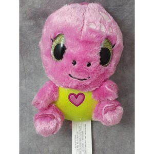 May include: Pink plush turtle with a yellow shell and a pink heart on the front. The turtle has sparkly green eyes and a smiling face.