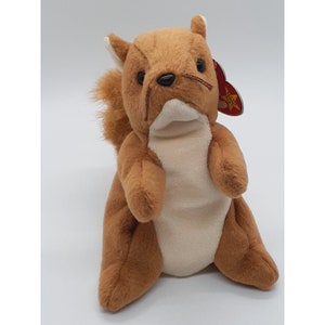 May include: A brown and white plush squirrel toy with a red and yellow tag that says "Ty" and has a star on it.