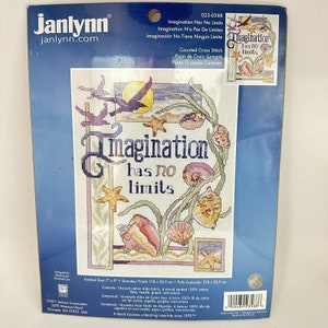 May include: A counted cross stitch pattern featuring a seashell design with the text "Imagination has no limits". The pattern is on a blue background with a white border. The finished size is 17.8 x 22.9 cm.