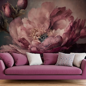 May include: A close-up of a large, pink peony flower against a dark background. The flower is in focus, and the background is blurred. The flower has many petals, and the centre of the flower is visible.