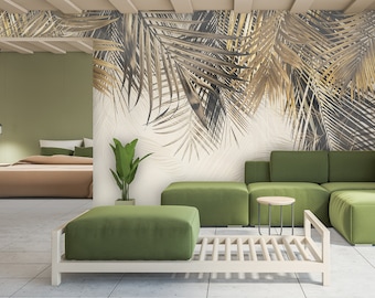 May include: A living room interior design with a green sectional sofa and a large wall mural featuring a tropical palm leaf design in gold and brown tones.