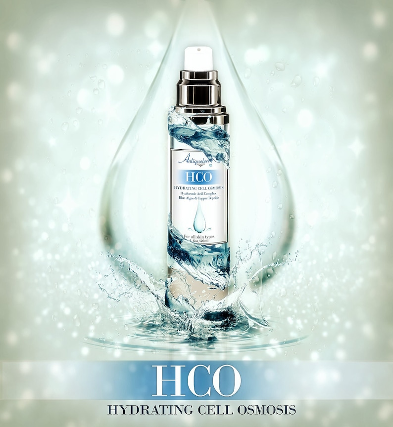 Puede incluir: Una botella de vidrio transparente de suero HCO Hydrating Cell Osmosis con una tapa plateada. La botella est&aacute; rodeada de gotas de agua y un chapoteo de agua.