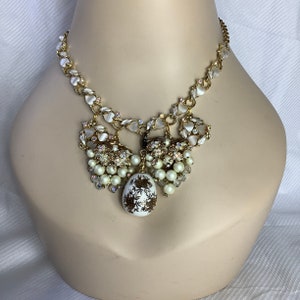 Assemblage necklace with cream and gold colored vintage pieces