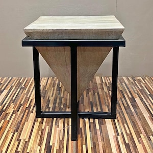May include: A triangular wooden table with a black metal frame. The table has a light wood finish and a simple design.