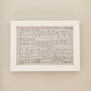 May include: A framed sheet of music with the title "Direct music N.3 Anna u. Maria Langer" and the composer's name "Egor Prandzhe" and the date "2018". The music is written in black ink on white paper.