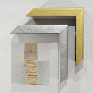 May include: Two picture frames, one silver and one gold, with a close-up of the wood frame showing the dimensions: 0.8" x 1.1" x 1.5".