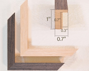 May include: Close-up of three wooden picture frame corners in different colors: dark brown, light brown, and natural wood. The frame is 1 inch thick, 0.7 inches wide, and 0.3 inches deep. The overall design is a simple, modern style.