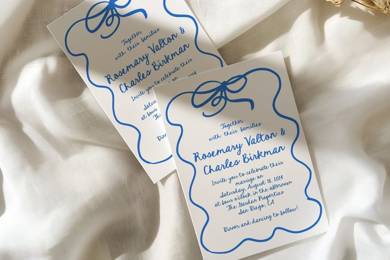 May include: A white wedding invitation with blue calligraphy. The invitation features a blue ribbon bow and the text "Together with their families Rosemary Valton & Charles Birkman Invite you to celebrate their marriage on Saturday, August 13, 2014 at four o'clock in the afternoon The Garden Properties San Diego, CA Dinner and dancing to follow!"