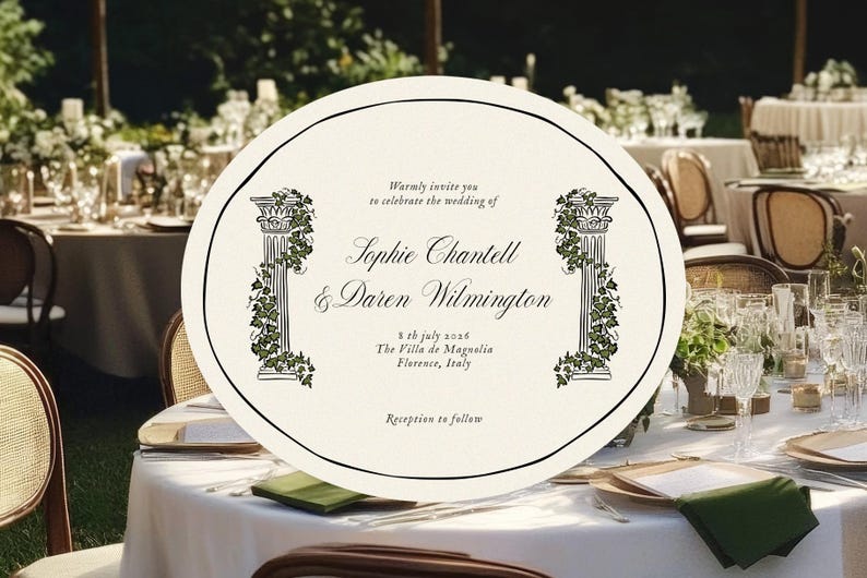 May include: An ivory wedding invitation with black text and decorative columns with green vines. The invitation is oval-shaped and sits on a white tablecloth, surrounded by wedding reception details.