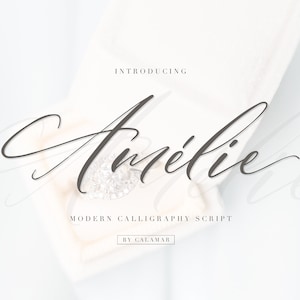 May include: A diamond ring in a white velvet box. The ring is the focal point, with a large, clear stone. The text reads "Introducing Amélie Modern Calligraphy Script by Calamar."