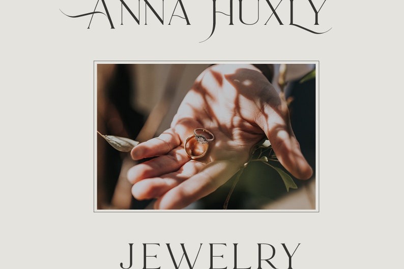 May include: Two gold wedding bands with a diamond ring on top, resting in the palm of a hand.