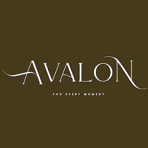 May include: White text on a brown background reads "AVALON" in a script font with a flourish on the "A" and "N". Below the text is "FOR EVERY MOMENT" in a smaller font.