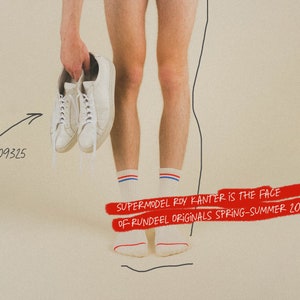May include: A person wearing white socks with red and blue stripes is holding a pair of white sneakers. The text "SUPERMODEL ROY KANTER IS THE FACE OF RUNDEEL ORIGINALS SPRING-SUMMER 2024" is written in red on a white background.