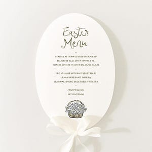 May include: White oval card with a handwritten Easter menu. The menu includes roasted artichokes,  believeres eggs,  tomato brichetta, leg of lamb, lemon herb roast chicken, seasonal spring vegetable frittata, mini pavlova, and hot cross buns. A small illustration of a basket of flowers is at the bottom of the card.