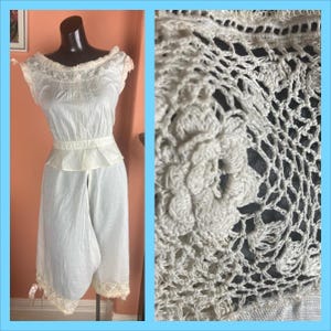 May include: White cotton undergarment with lace trim and a gathered waist. The garment has a split in the back and is made of a lightweight fabric.
