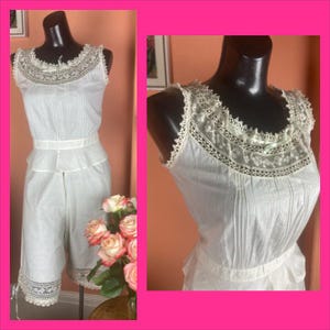 May include: White cotton lingerie set with lace trim. The top has a scalloped neckline and the bottom is a pair of bloomers.