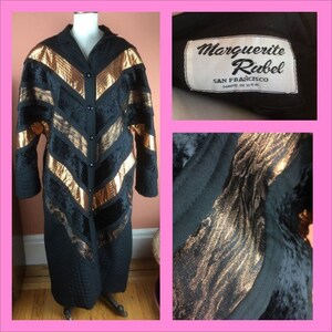 May include: A long black quilted coat with gold and black velvet chevron stripes. The coat has a button closure and a label that reads "Marguerite Rubel, San Francisco, Made in U.S.A."