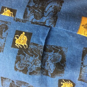 May include: Blue fabric with a repeating pattern of black and gold insects. The fabric has a textured weave.