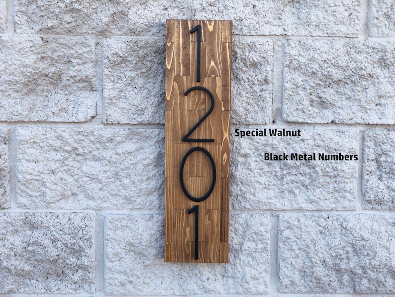 May include: A wooden sign with the numbers 1201 in black metal lettering. The sign is made of special walnut wood.