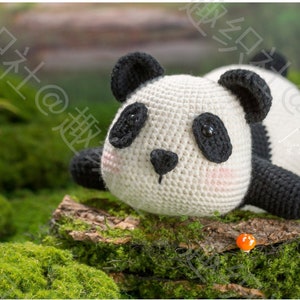 front view of big head cute panda lying on his chin, and tummy on rock, panda is in at right side of picture, in white and black, pale pink tint on cheeks, panda having big butt sticking high in air, arms and legs are short, with garden background