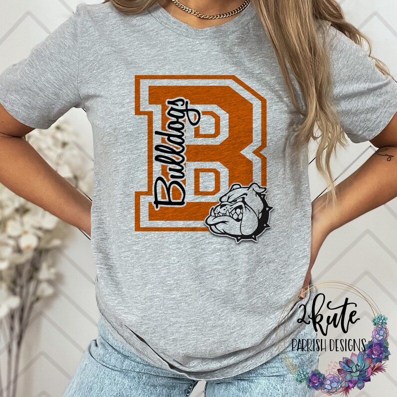 May include: Gray t-shirt with an orange letter "B" and the word "Bulldogs" printed on it. A cartoon bulldog head is below the letter.