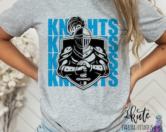 May include: Gray t-shirt with a blue graphic of a knight in armor holding a sword. The graphic is repeated multiple times and says "Knights" in blue letters.