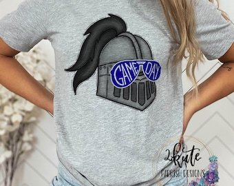 May include: Gray t-shirt with a graphic of a knight's helmet wearing sunglasses that say "Game Day".