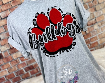 May include: Gray t-shirt with a red paw print and the word "Bulldogs" in black lettering. The paw print has a leopard print design.