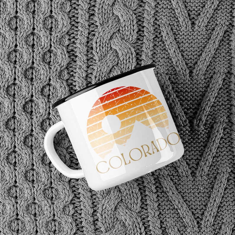 Born to be in the Great Outdoors, this custom Retro Colorado Sunset enameled camp mug is an outdoor lovers best sidekick. With 12oz for your favorite beverage, these camping mugs are made of metal, making them a hard-wearing choice for any adventure.