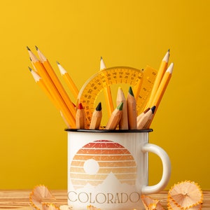 Born to be in the Great Outdoors, this custom Retro Colorado Sunset enameled camp mug is an outdoor lovers best sidekick. With 12oz for your favorite beverage, these camping mugs are made of metal, making them a hard-wearing choice for any adventure.