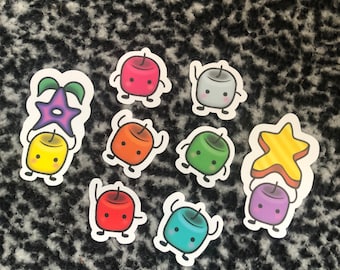 May include: A selection of colourful stickers featuring cartoon characters. The stickers show a star and marshmallow-like figures in red, orange, green, blue, yellow, grey, and purple. Each character has a smiling face and waving arms.