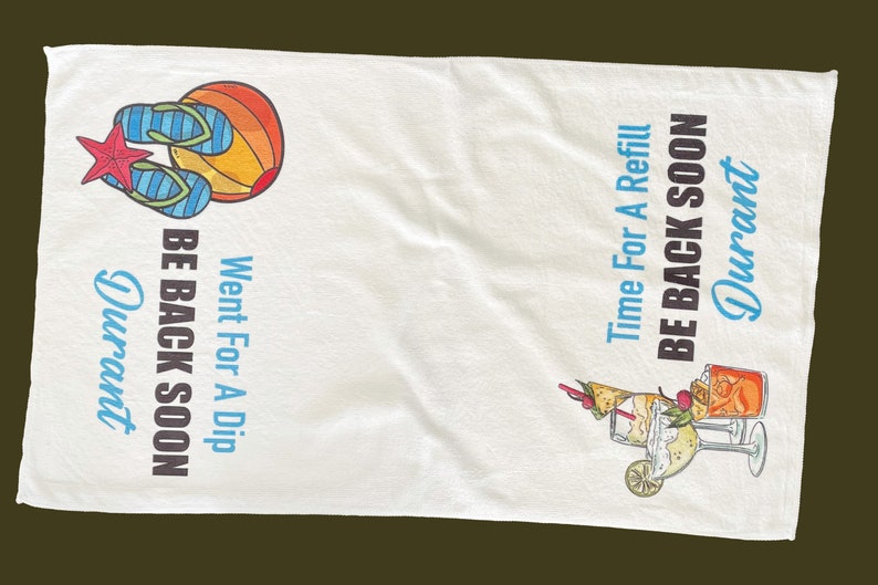 May include: White beach towel with colorful illustrations of flip-flops, a sunset, and cocktails. Text reads "Went For A Dip, Be Back Soon, Durant" and "Time For A Refill, Be Back Soon, Durant."