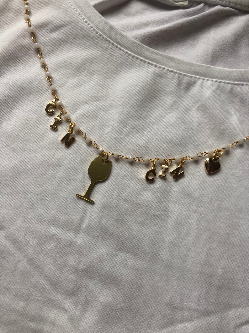 Rosary-type necklace with pendants and CIN CIN writing