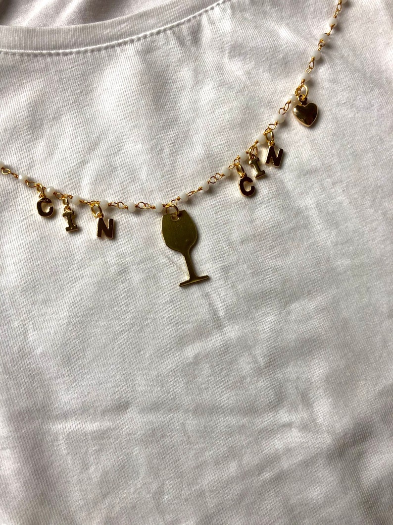 Rosary-type necklace with pendants and CIN CIN writing