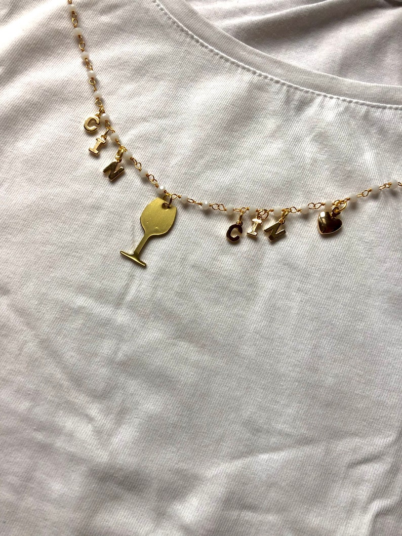 Rosary-type necklace with pendants and CIN CIN writing