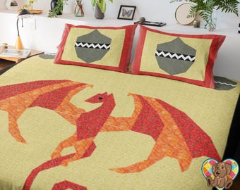 May include: A yellow and orange dragon quilt with red accents. The quilt features a dragon design with a geometric pattern. The quilt is on a bed with two pillows with a gray and white shield design.
