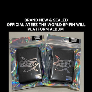 May include: Two sealed, brand new ATEEZ The World EP Fin Will platform albums. The albums are black with silver lettering and a silver graphic design. The albums are in clear plastic packaging with a holographic iridescent finish.