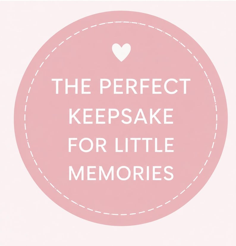 May include: A circular light pink graphic featuring a white dashed border and a small white heart icon at the top. The text in white capital letters reads: THE PERFECT KEEPSAKE FOR LITTLE MEMORIES. The design is centered on a solid light pink background.