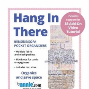May include: A sewing pattern for a bedside or sofa pocket organizer. The pattern includes multiple fabric and mesh pockets, side loops for cords or eyeglasses, and comes in two sizes. The pattern is called "Hang In There" and is by Annie.com.