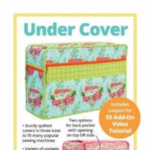 May include: A quilted sewing machine cover with a floral print in shades of blue, green, and pink. The cover has a zippered pocket and a flap with magnetic snaps. The text "Under Cover" is printed in large, bold letters at the top of the image. The text "Protect your cherished machine" is printed at the bottom of the image.