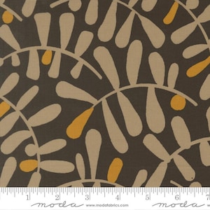 May include: Fabric with a repeating pattern of stylized leaf shapes in beige, yellow, and white against a dark brown background. The design is arranged in a semi-circular pattern. The fabric has a ruler along the bottom with the word "moda" printed on it.