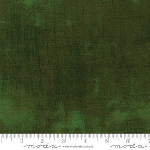 Op de afbeelding: Donkergroene stof met een getextureerde, verweerde uitstraling. De stof heeft een gevlekt effect met lichtere groene vlekken en donkerdere groene gebieden, wat een vintage of rustieke uitstraling creëert. Geschikt voor quilten en knutselprojecten.
