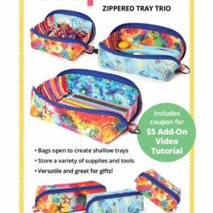 May include: A set of three colorful zippered trays with a "Drop Zone" title and the text "Zippered Tray Trio". The trays are made of fabric and have a variety of patterns. The trays are open to show the interior, which is lined with a contrasting fabric. The text "Includes coupon for $5 Add-On Video Tutorial" is also visible.
