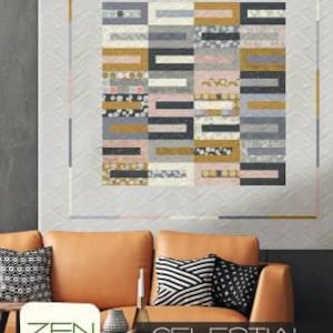 May include: A large, rectangular quilt with a geometric design of rectangular blocks in shades of gray, gold, pink, and black. The quilt is displayed on a wall above a brown leather sofa with patterned pillows. The text "CELESTIAL STRIPES" is visible.