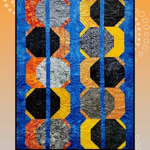 May include: A quilt pattern called "Eclipses" by Creative Sewlutions for Villa Rosa Designs. The quilt features a geometric design of octagons in shades of orange, yellow, black, gray, and blue.